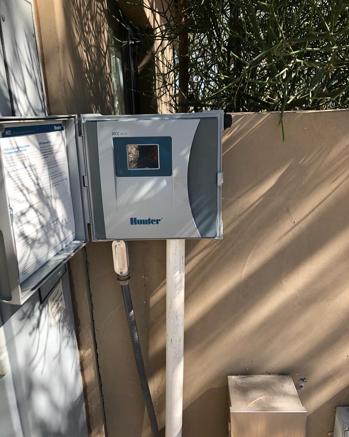 Irrigation controller mounted on a garden wall